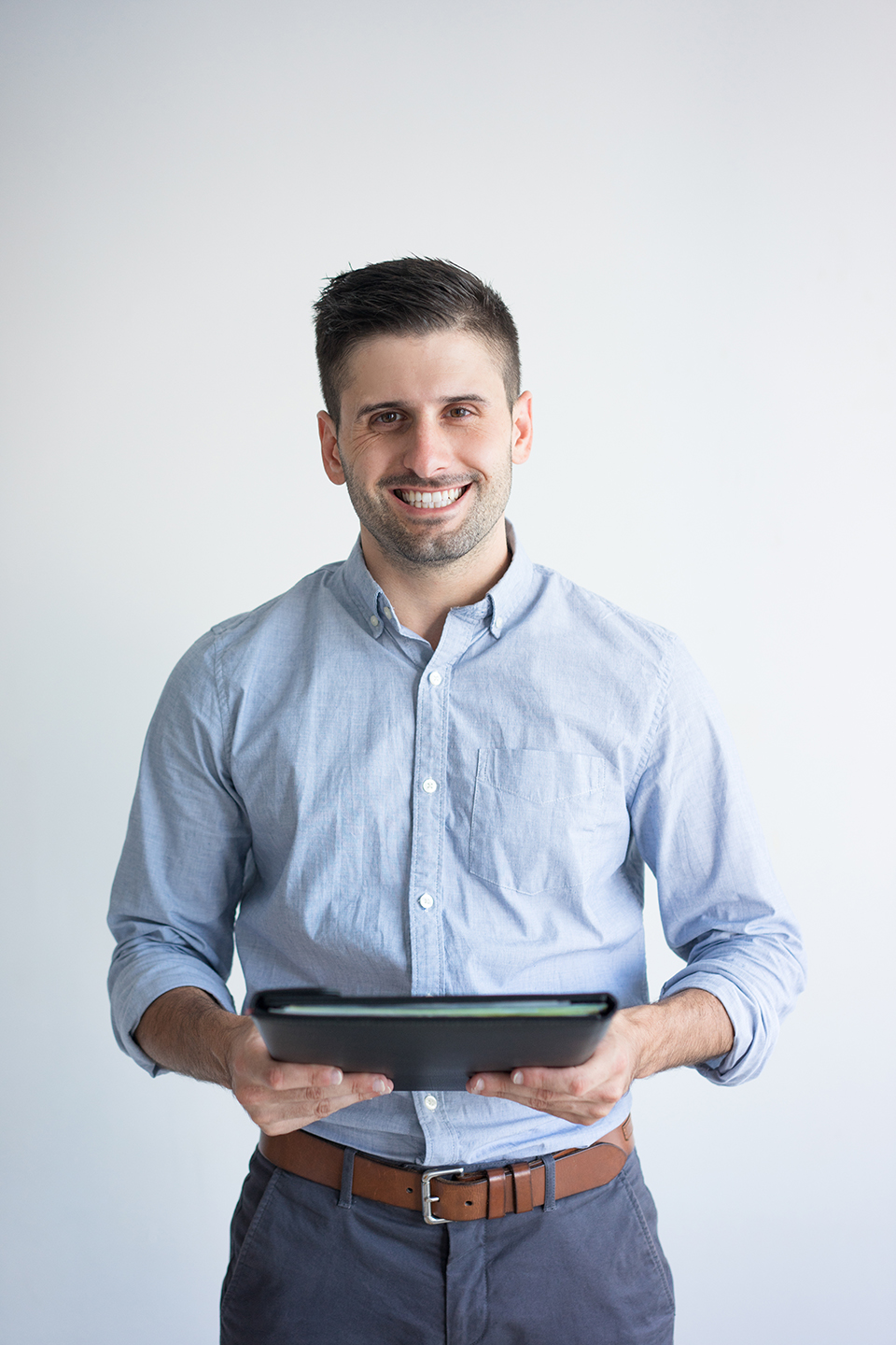 Portrait of smiling businessman holding folder with documents